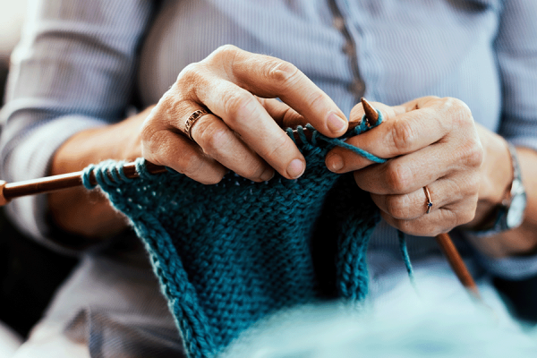 Close up of woman learning to knit